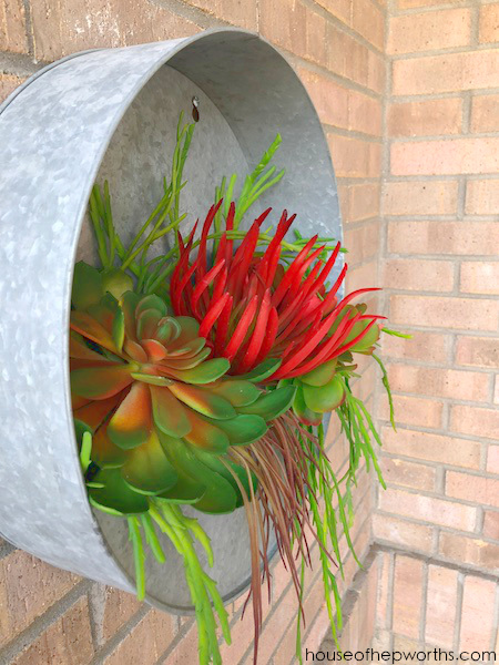 metal round wall planter with faux succulents