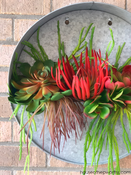 metal round wall planter with faux succulents